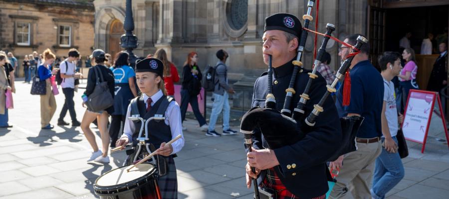 Piper and drummer in front of McEwan hall at Principal's Welcome 2023