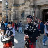 Piper and drummer perform outside McEwan Hall