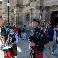 Piper and drummer perform outside McEwan Hall