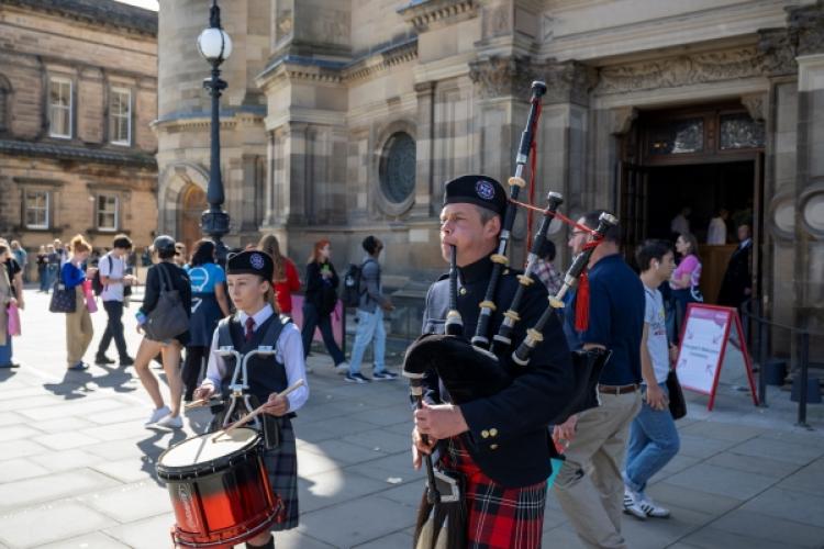 Piper and drummer perform outside McEwan Hall