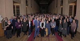 Colleagues at the University of Edinburgh celebrating their 20 years' service in the Playfair Library Hall. 